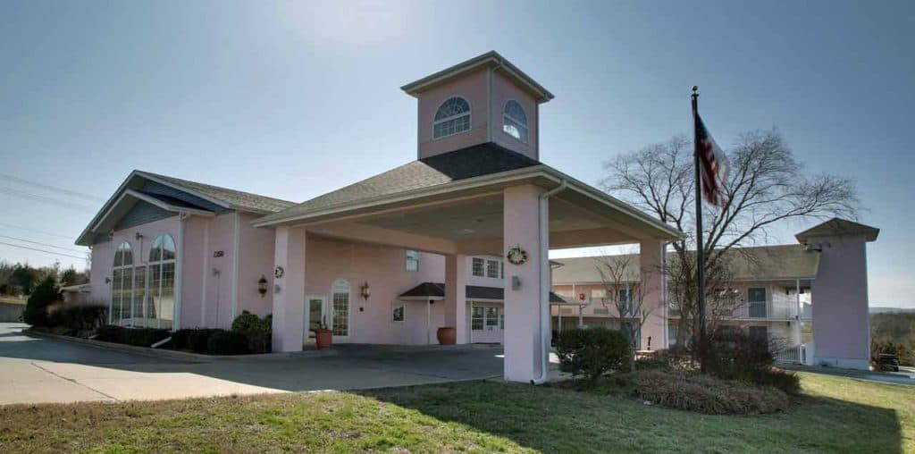 Exterior view of Angel Inn Central in Branson, Missouri, showing the covered entrance and hotel facade