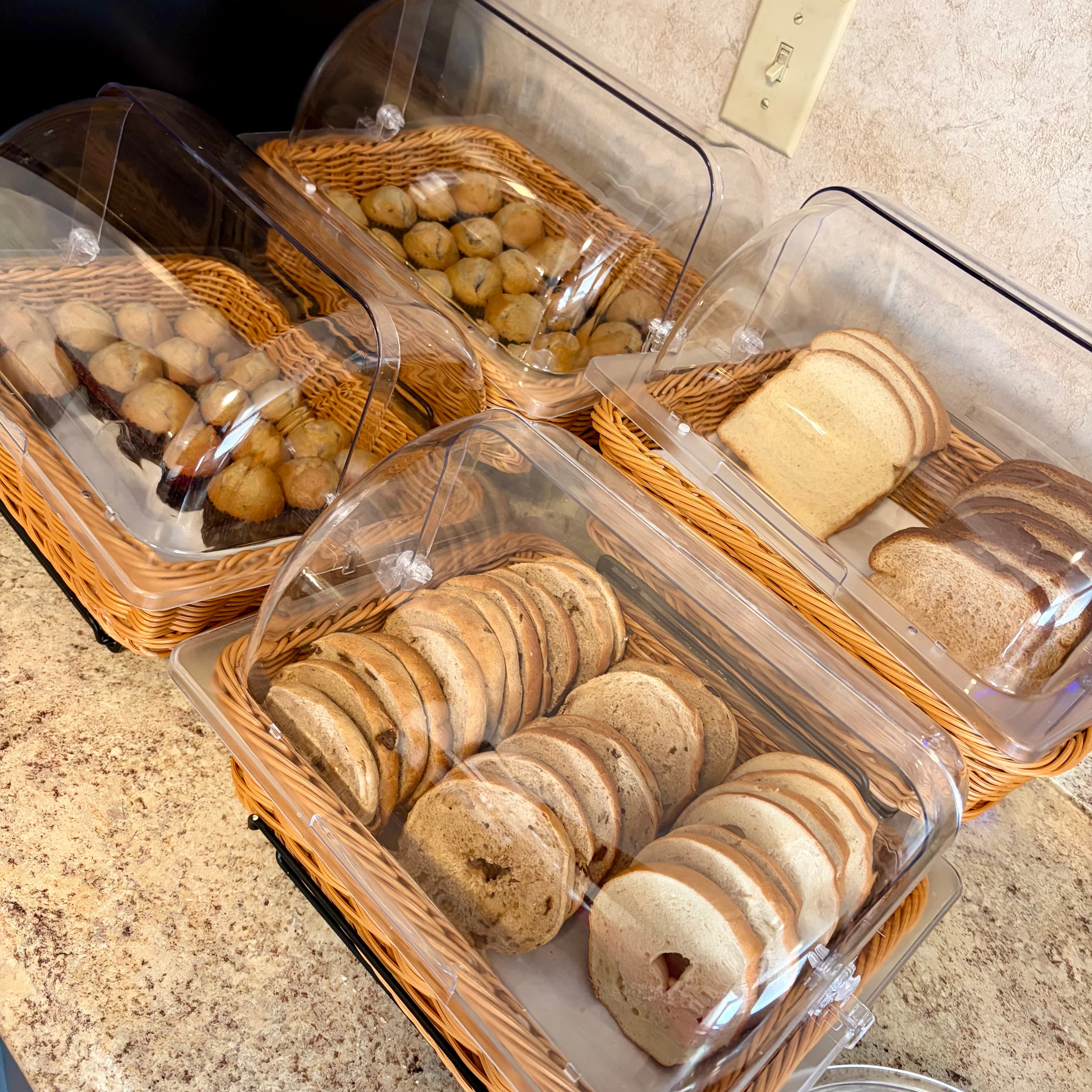 Bagels, muffins, and bread at the complimentary breakfast buffet at Angel Inn Central