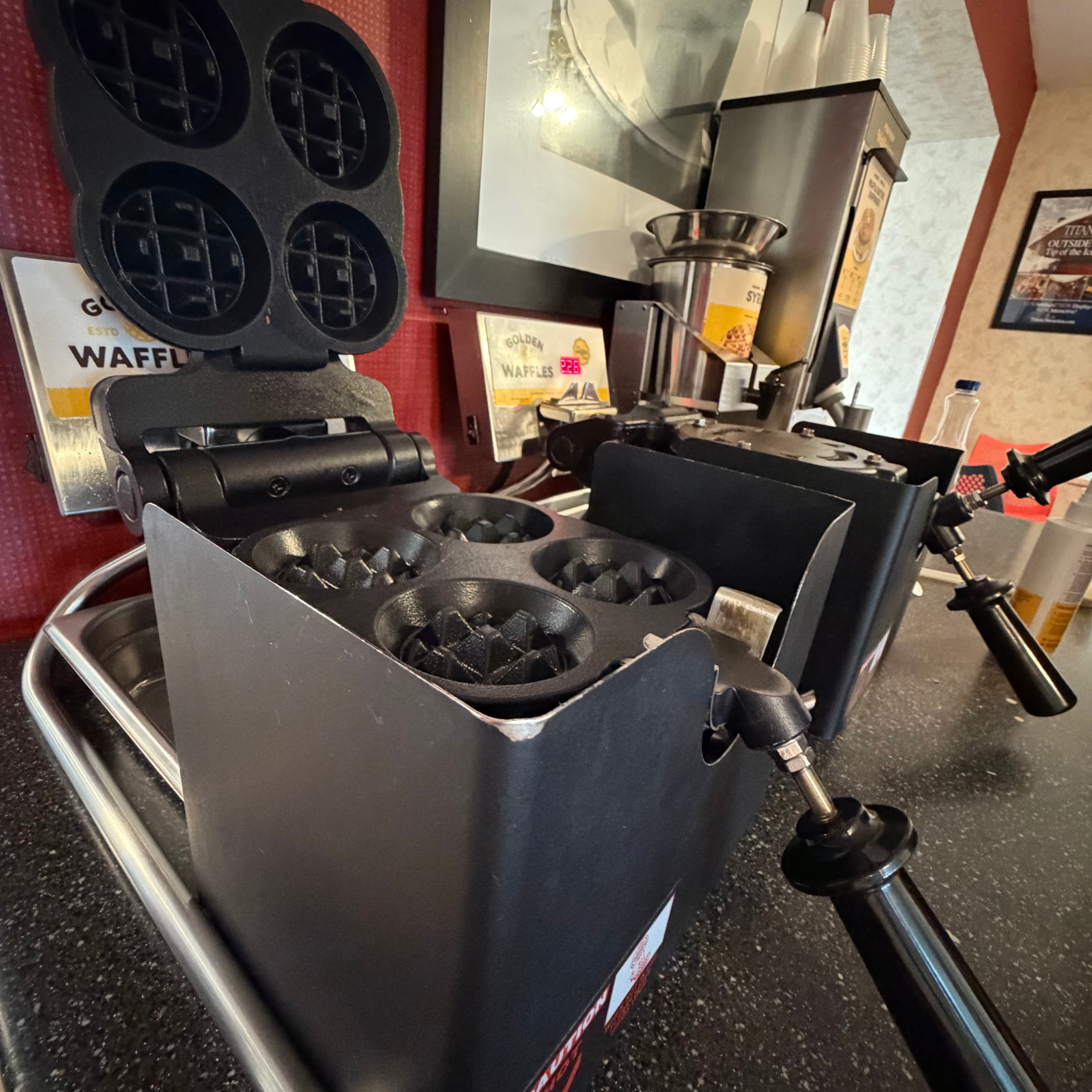 Golden waffle station in the complimentary breakfast area at Angel Inn Central